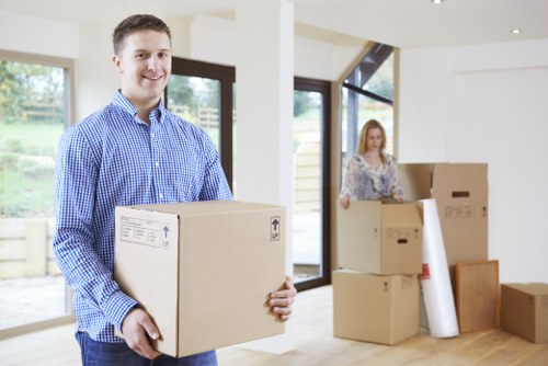 Removalists carrying furniture through a busy Elephant and Castle street