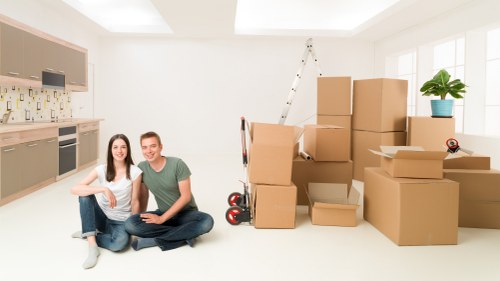 Removal team loading boxes and furniture for a South London house move